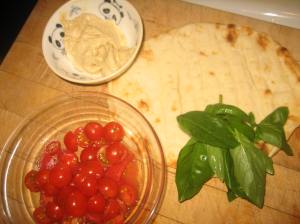 Tomatoes, hummus, flatbread, basil - ready for yummy action